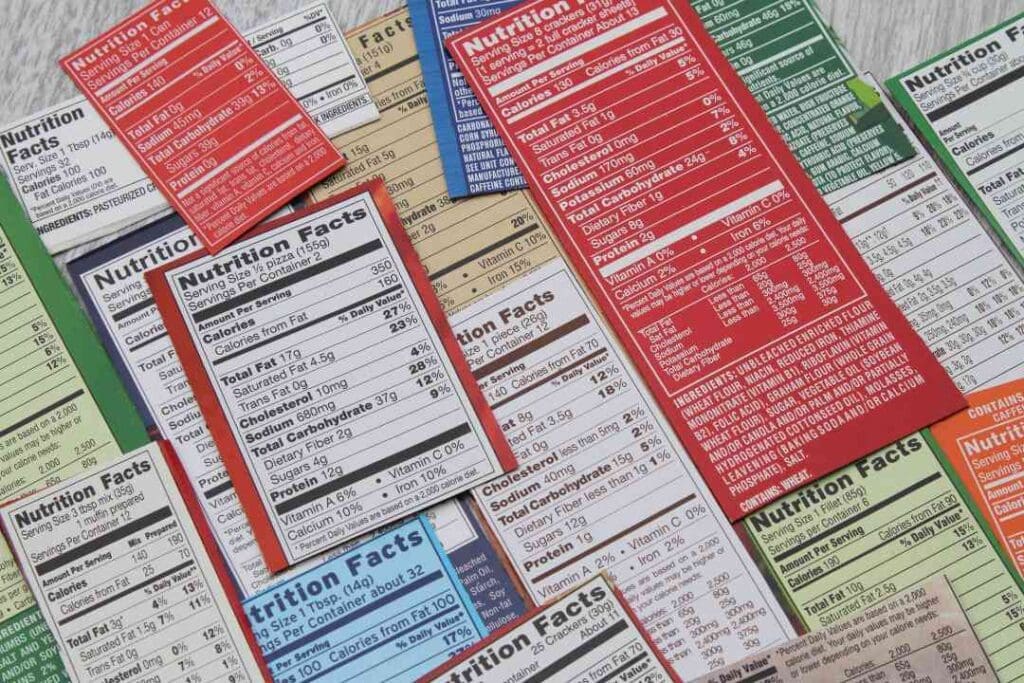 A variety of colorful nutrition labels laid out, emphasizing the importance of understanding food packaging and nutritional information.